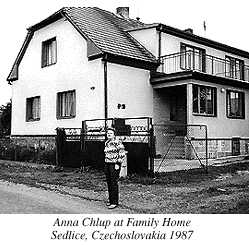 Photograph of Anna Chlup next to Family Home in Sedlice