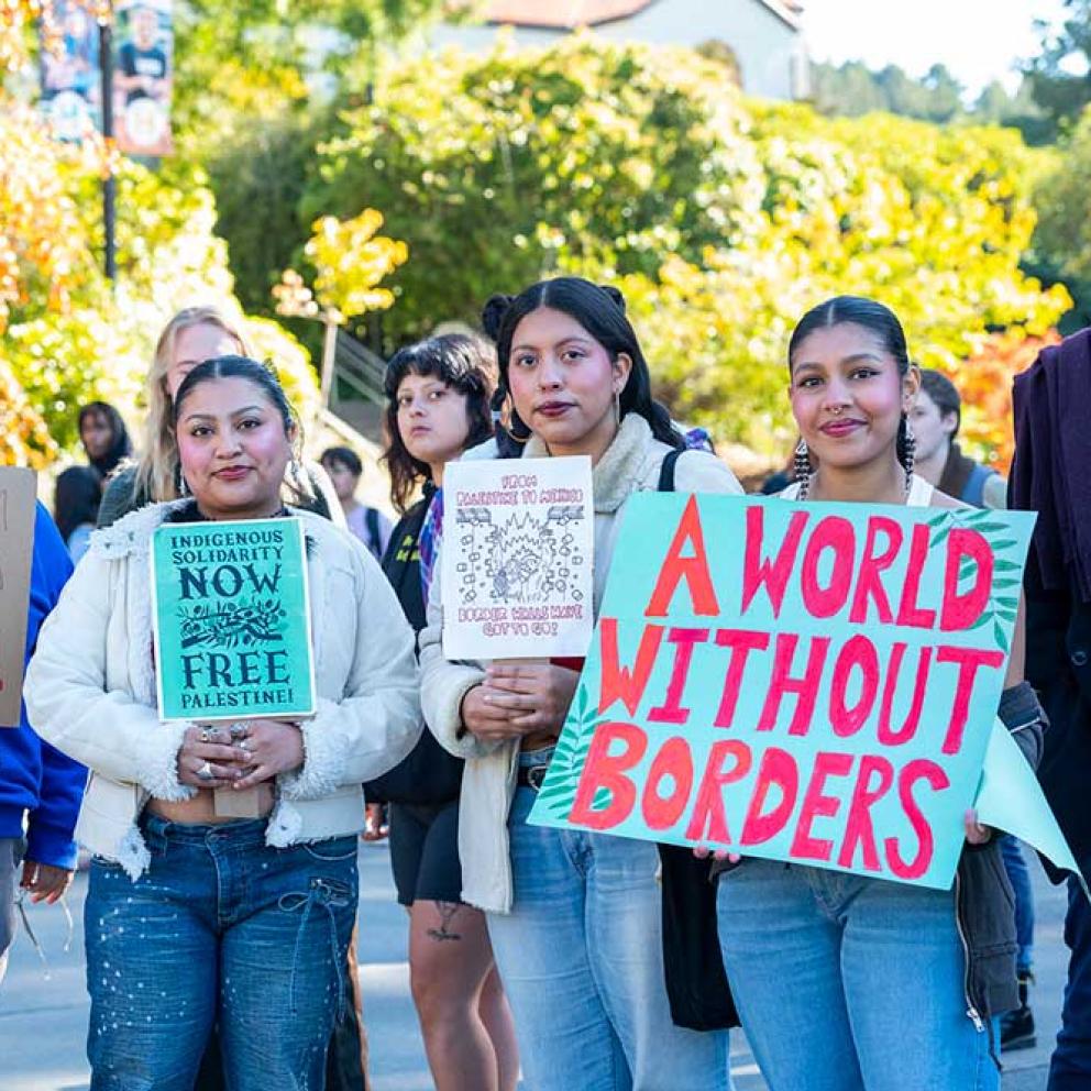 Students holding signs