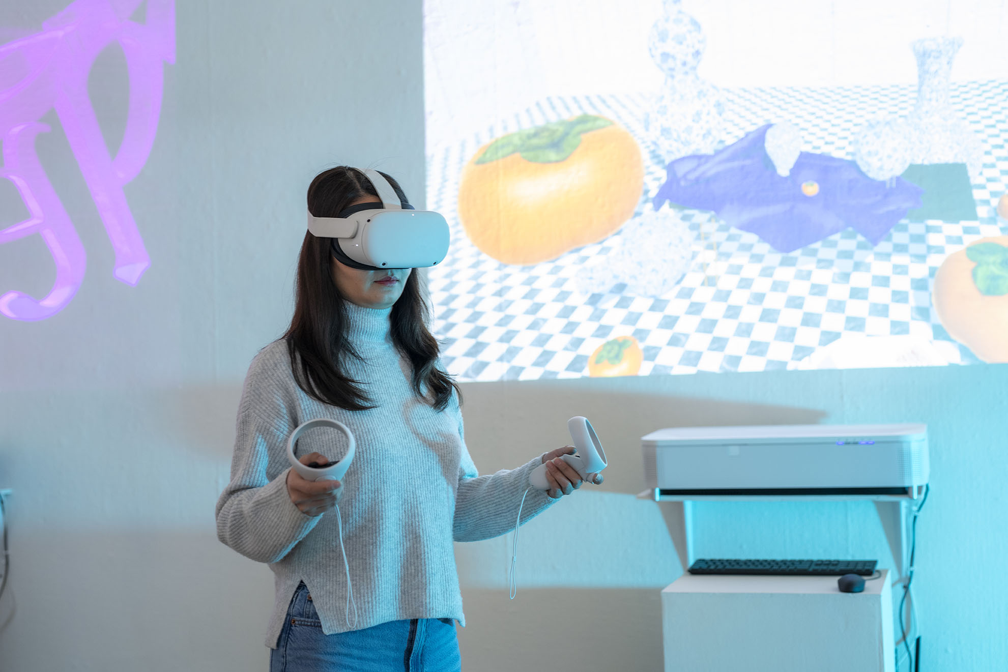 A woman wearing an oculus in front of a projection