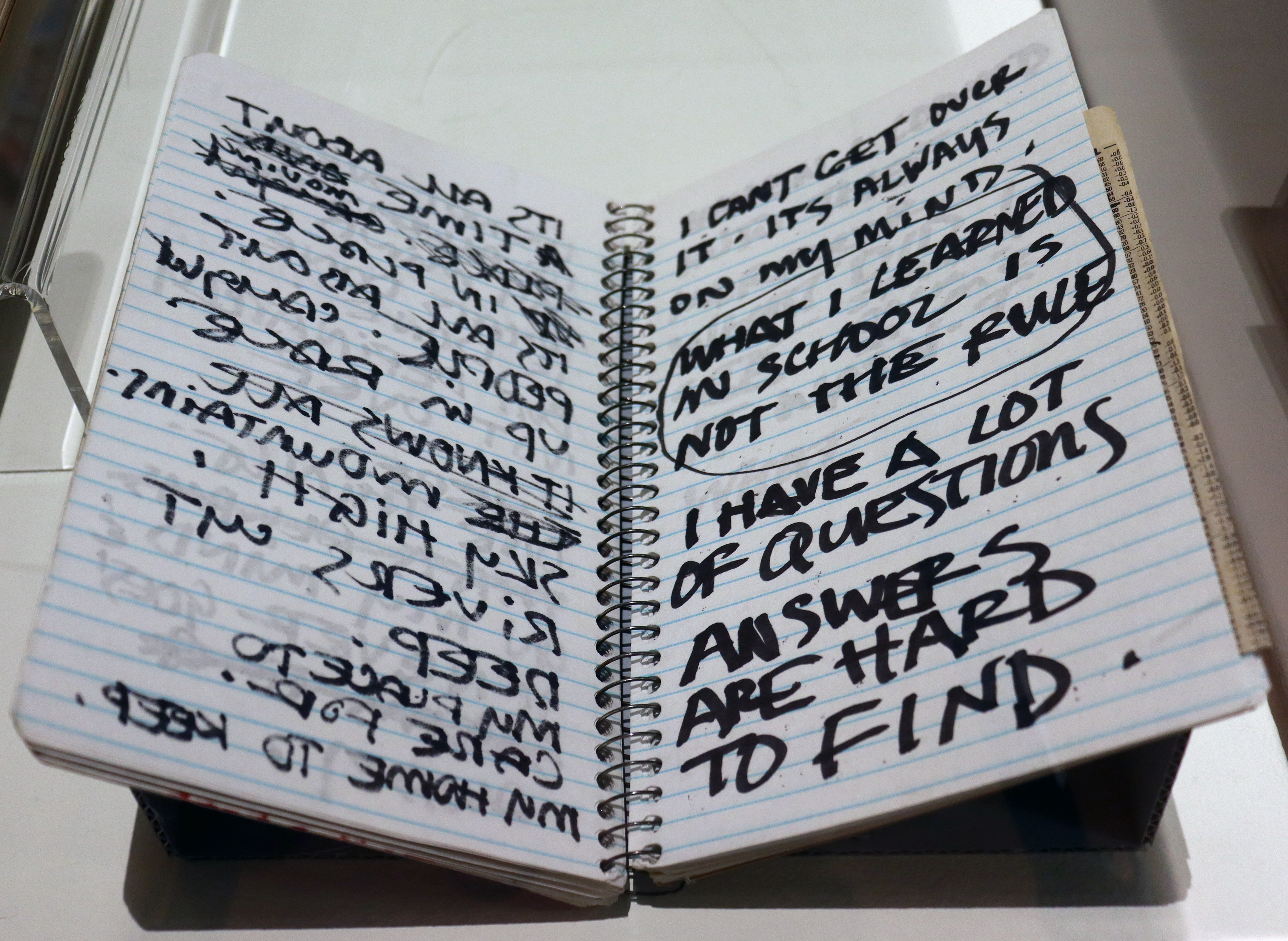 view of a sketchbook written in black sharpie pen - poems in handwritting