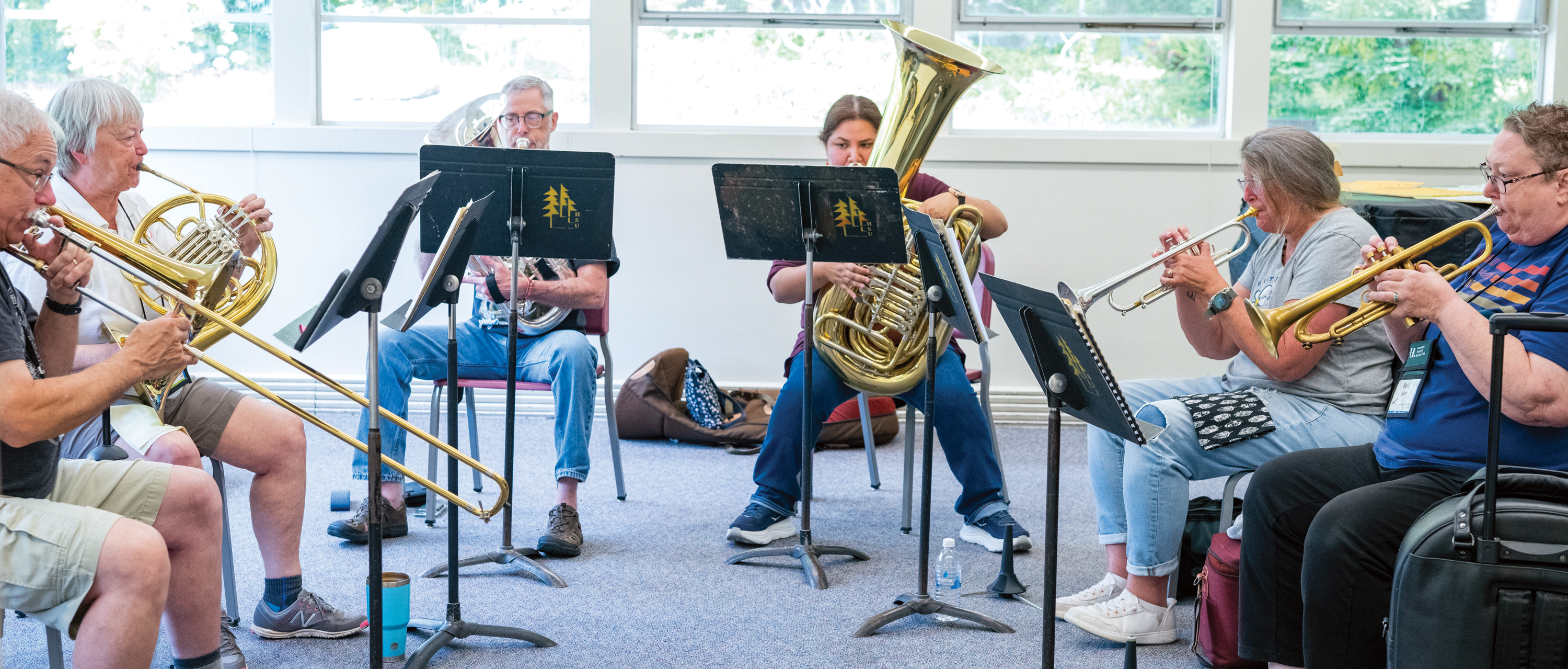 Group of brass players in a classroom
