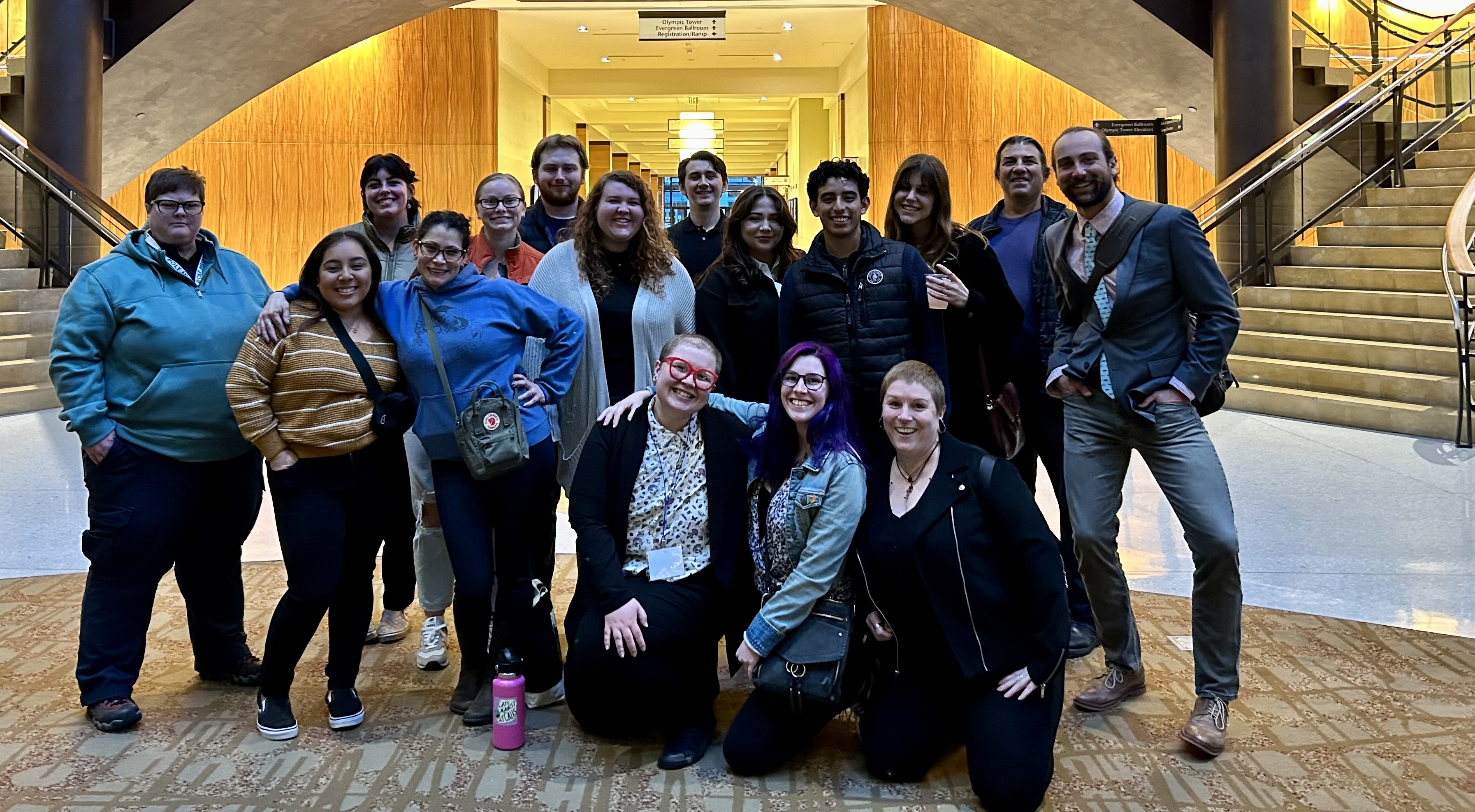 students standing in front of a large staircase