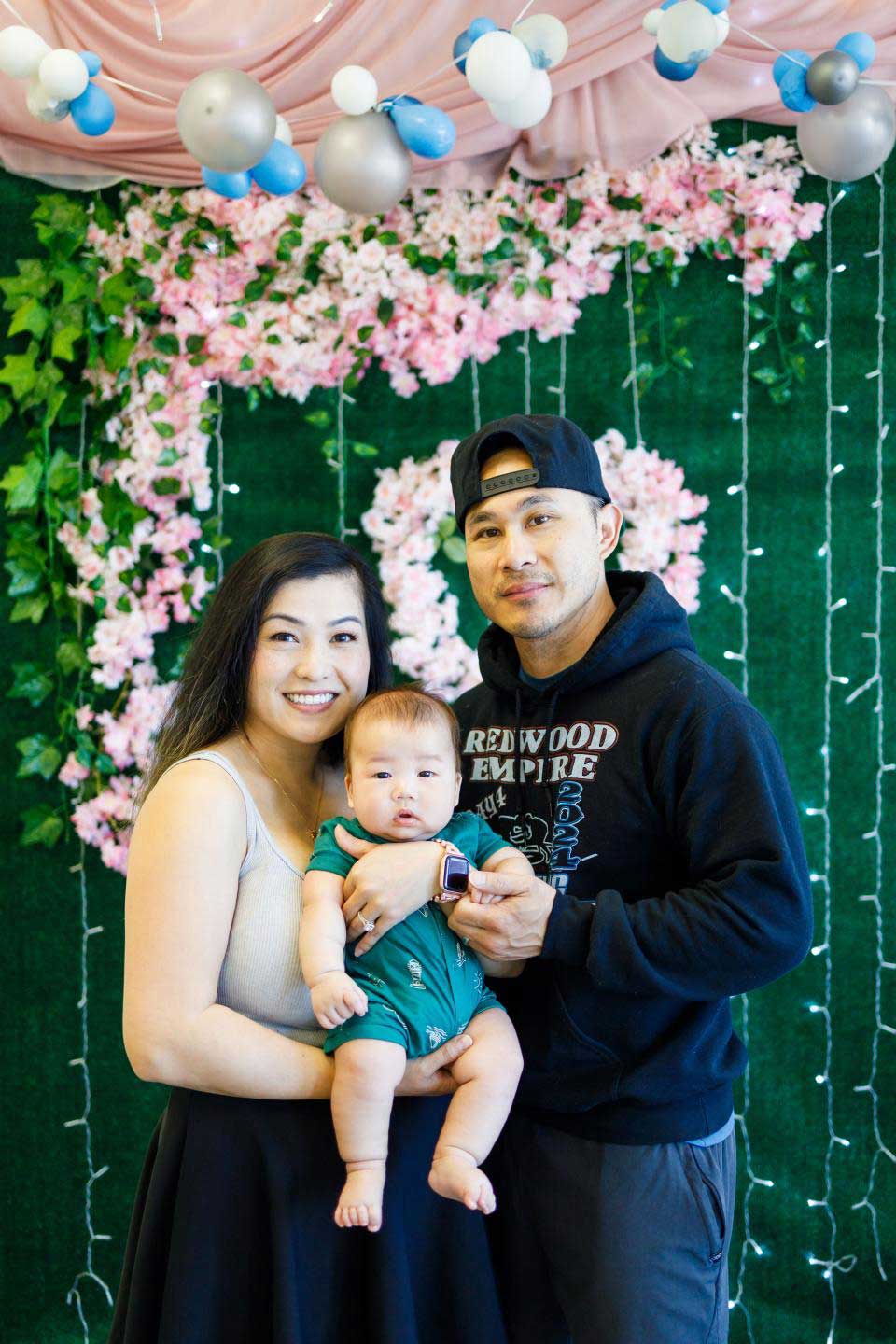 Poua Vang with her child and partner