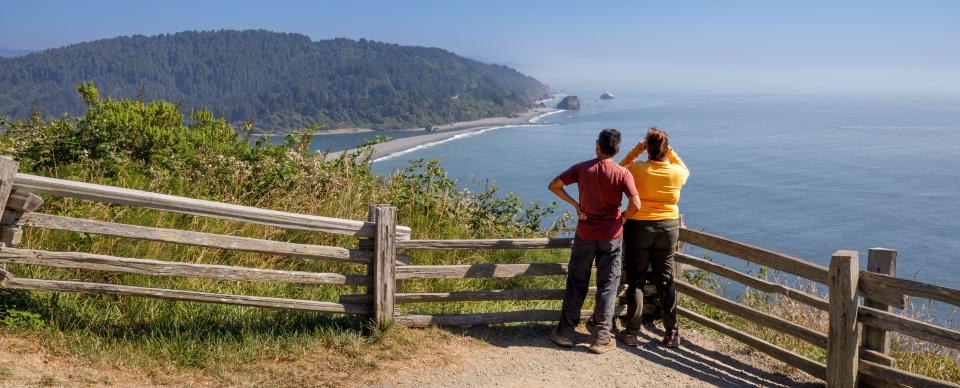 Two people at a coatsal overlook