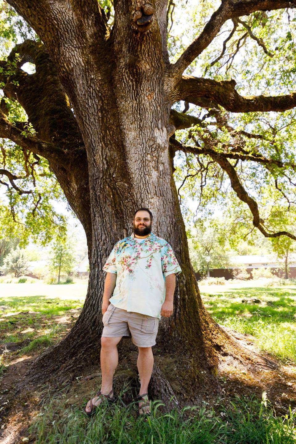 Michael Curl standing in front of a tree