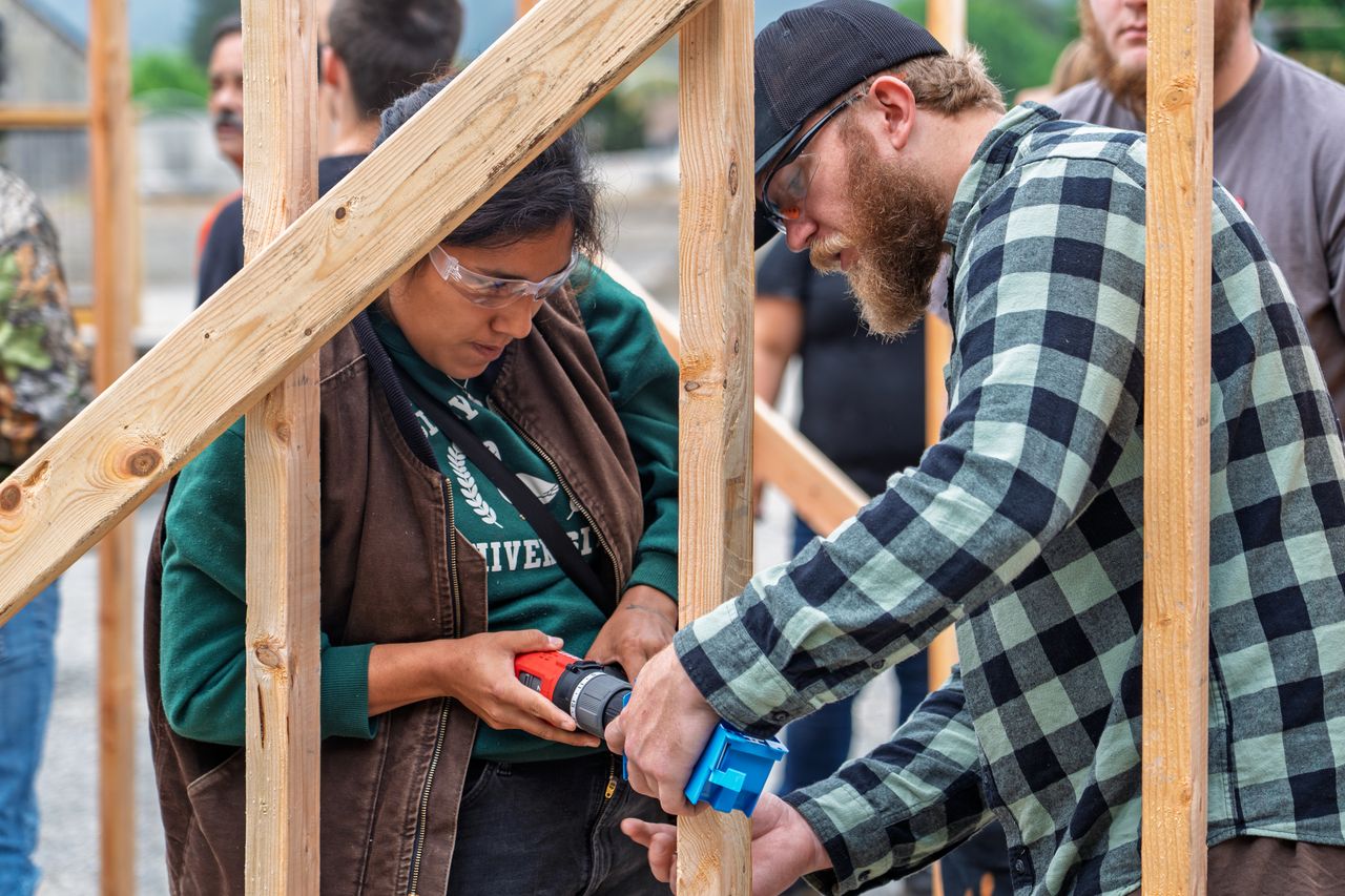 man and woman working together building
