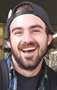 Benjamin up close portrait, wearing a black baseball cap backwards