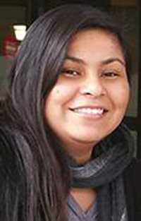 Chelsea portrait, up close, long dark hair and a dark gray scarf around the neck
