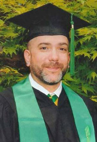 Jeffrey wearing a cap and gown