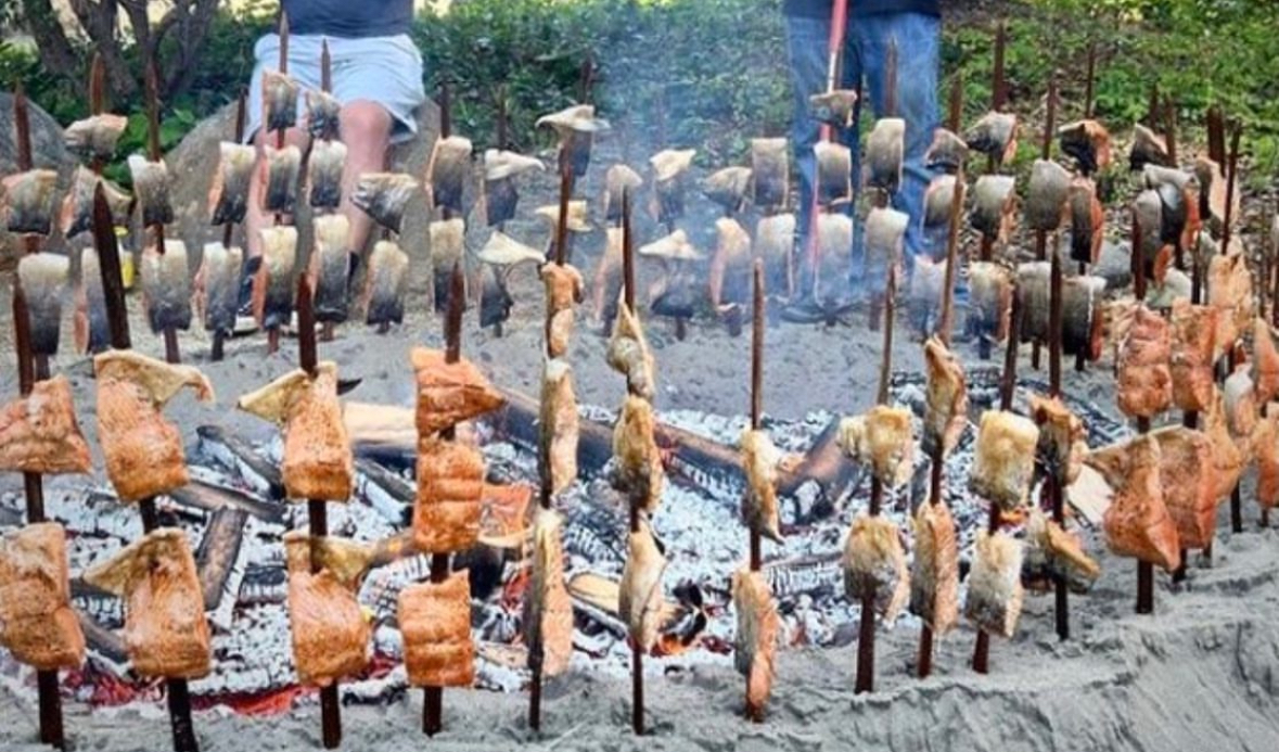 Image of Salmon on redwood pikes smoking around the FSL Salmon Pit.