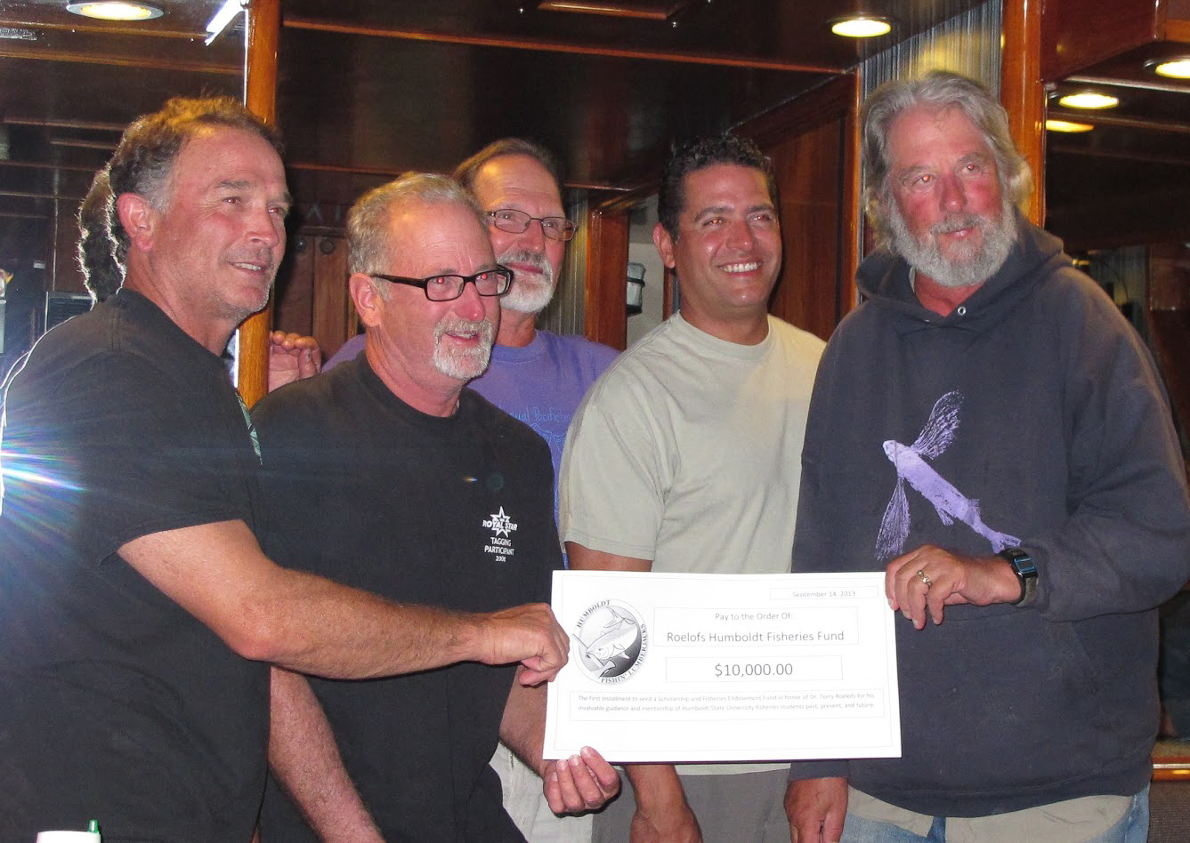 A photo of the Humboldt Fishin' Lumberjacks group presenting the funding to establish the Roelofs Humboldt Fisheries Endowed Award in 2015.