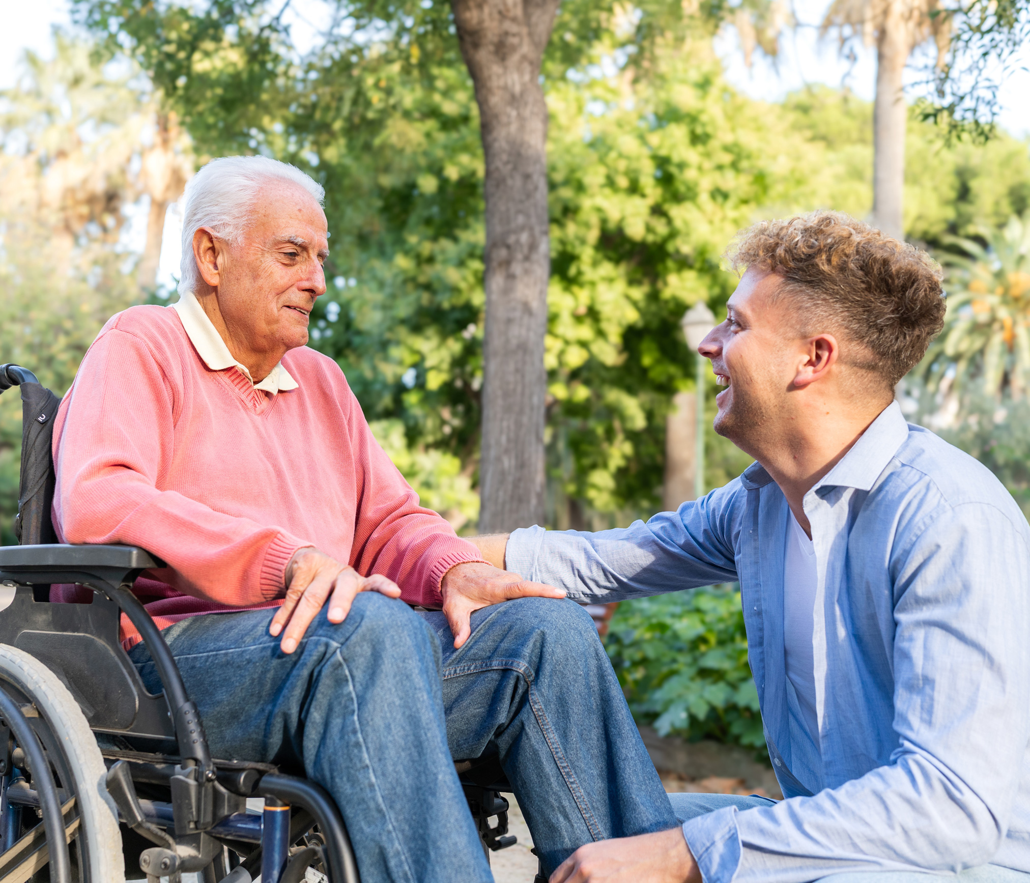 older man in wheelchair talking with younger man