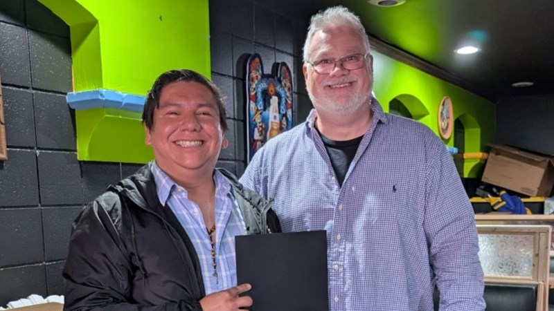 An econ professor and student smiling.