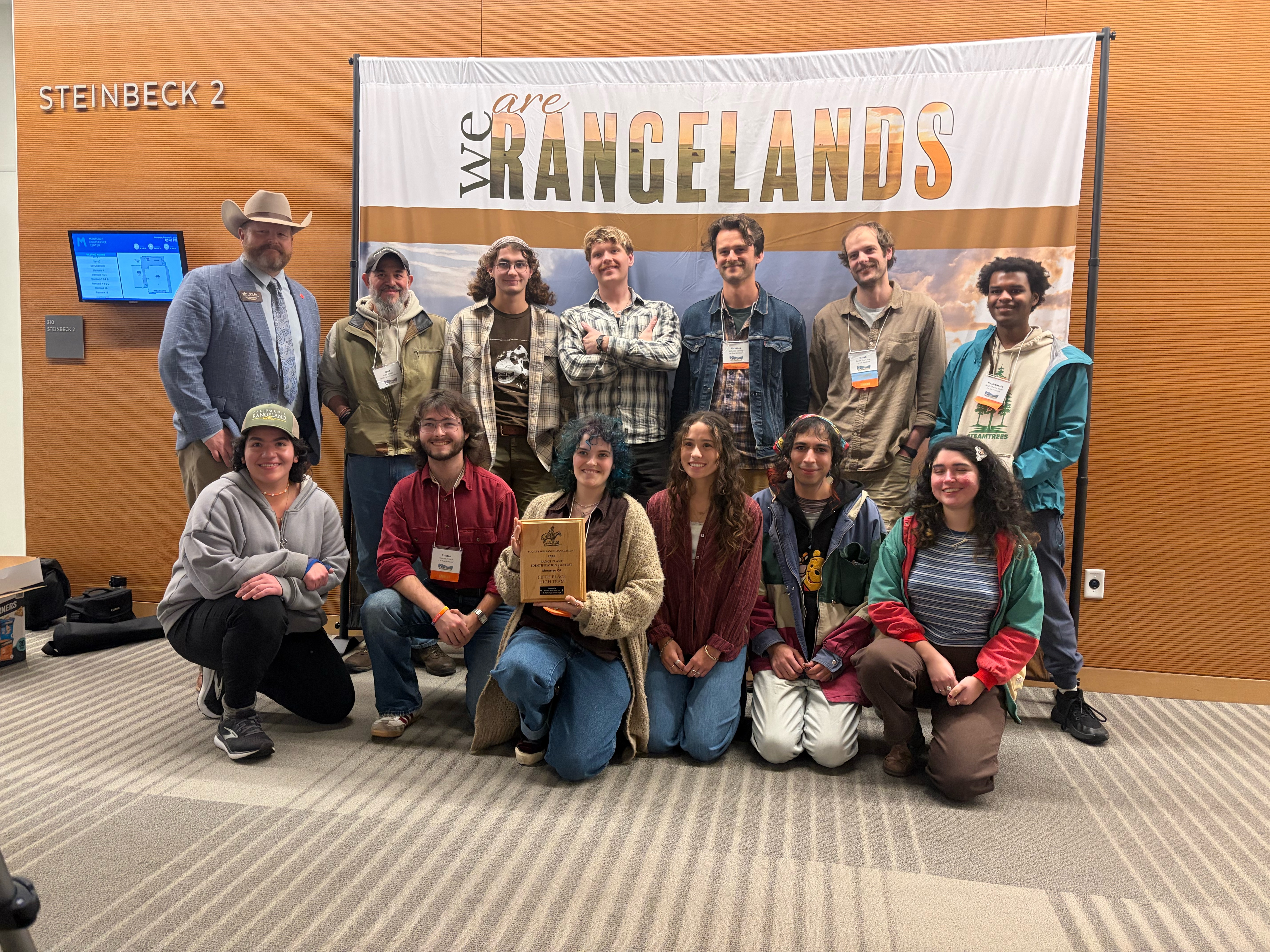 A group photo of 13 students and a teacher in the Soils and Range Club.
