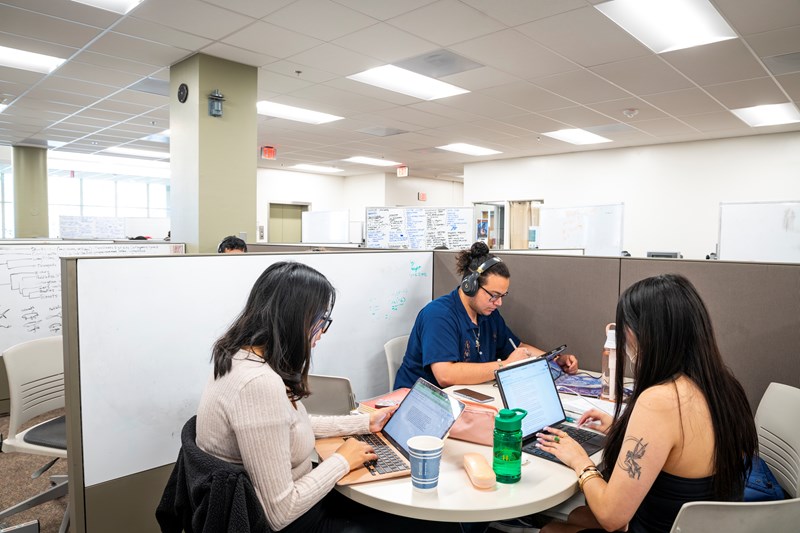 Three students studying in a student centered space in the Humboldt library.