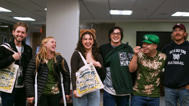 A group of six students with bags in the Humboldt Transfer Center.