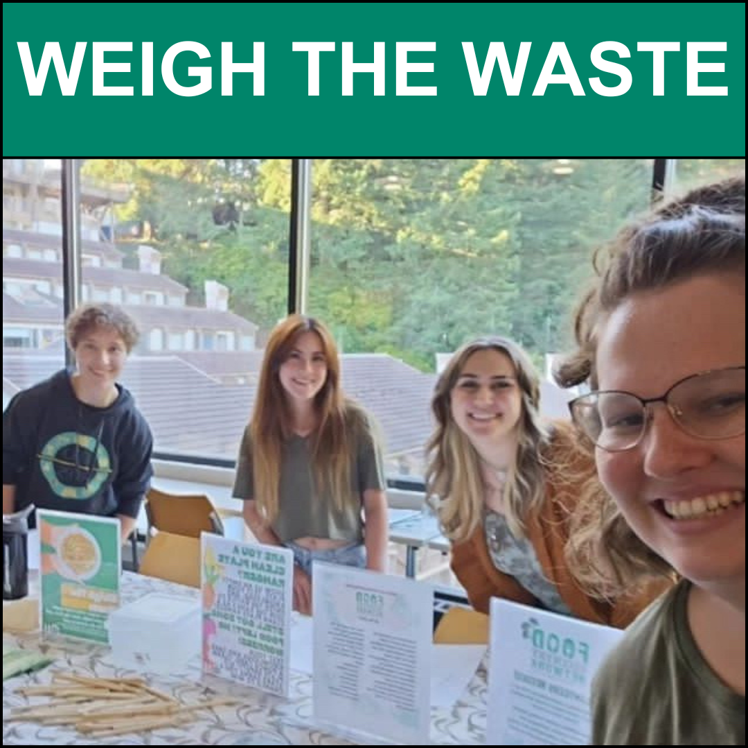 Photo of four coordinators tabling Weigh the Waste event at the J dining hall