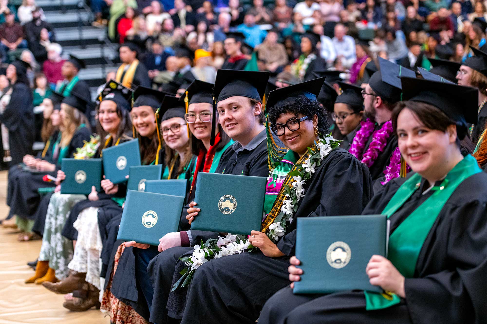 Graduates holding diploma