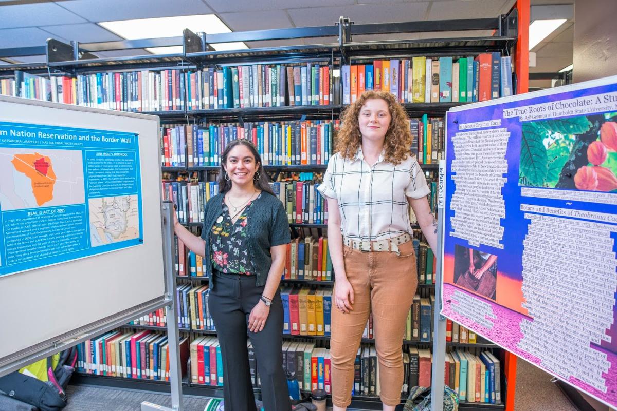 Two people with their posters