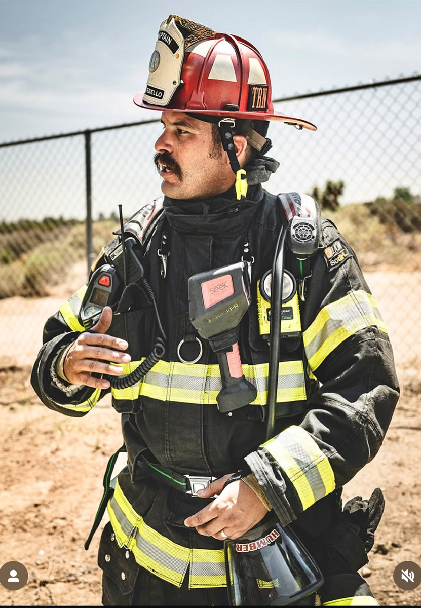 Zachary Humber in his fire fighting uniform and helmet