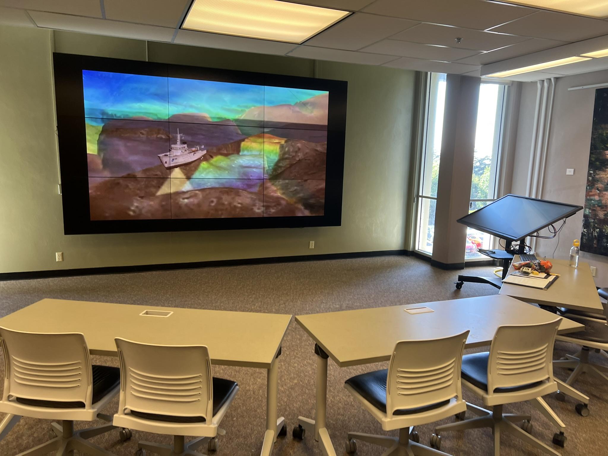 The Library Digital Wall showing a simulation of sea-floor mapping beneath a ship.