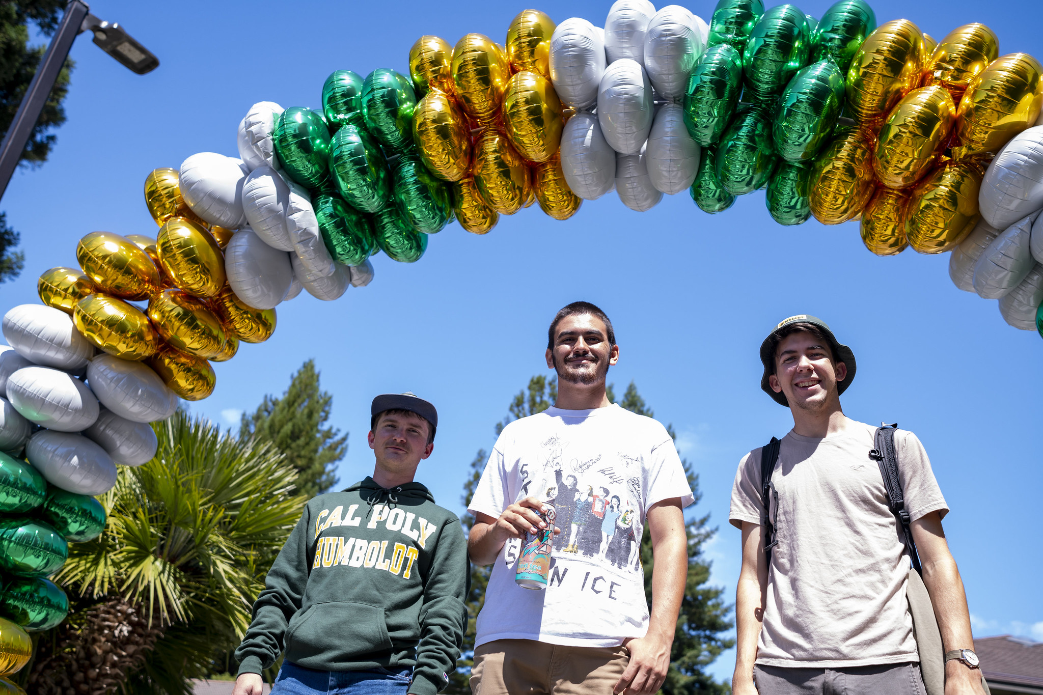 Students standing under balloon arch