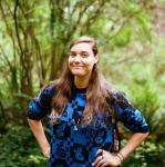 Francesca Messinam standing with hands on hips in a forest setting