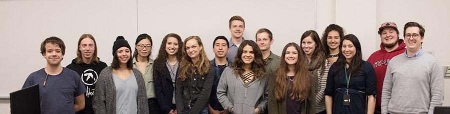 group of students in a row smiling for the camera