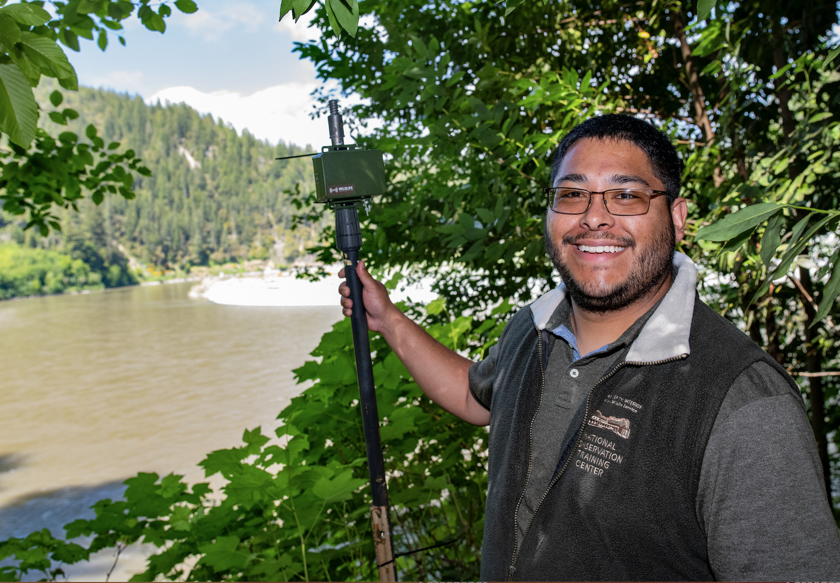A graduate student assists with bat study