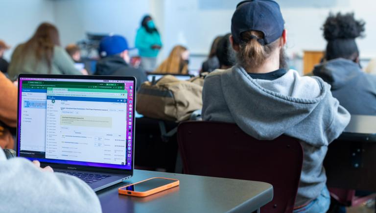 front of a laptop from the perspective of sitting in a class