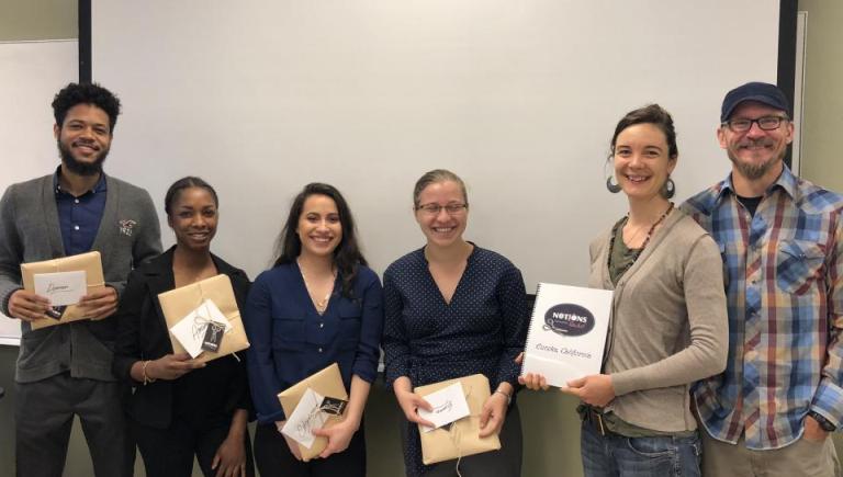 students holding plaques smiling