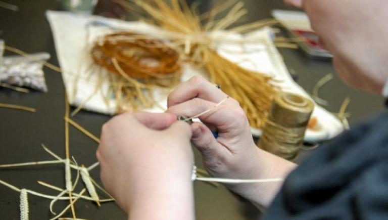Person working with grass strands