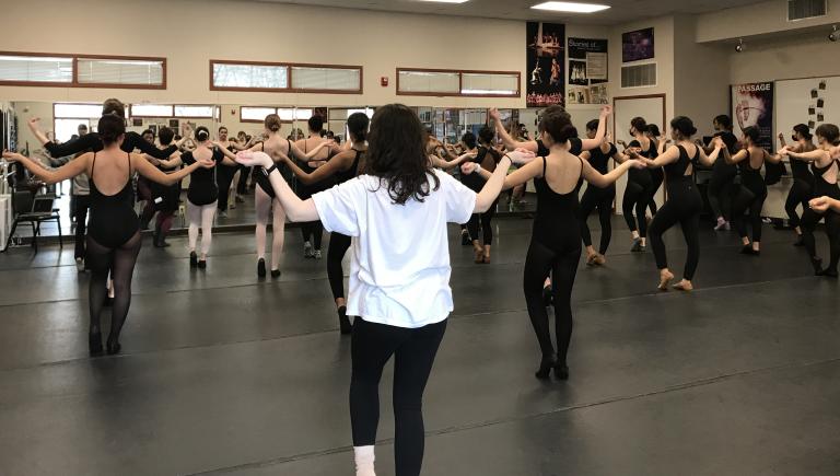 Cal Poly Students teaching students at Natomas Charter School a dance combination