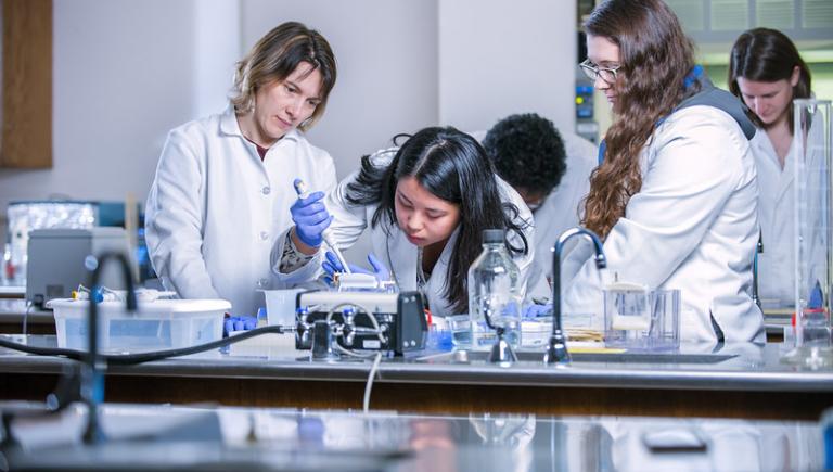 Biology professor with students sampling
