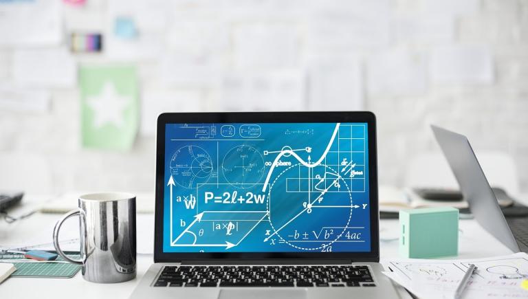 Laptop open with formulas on screen