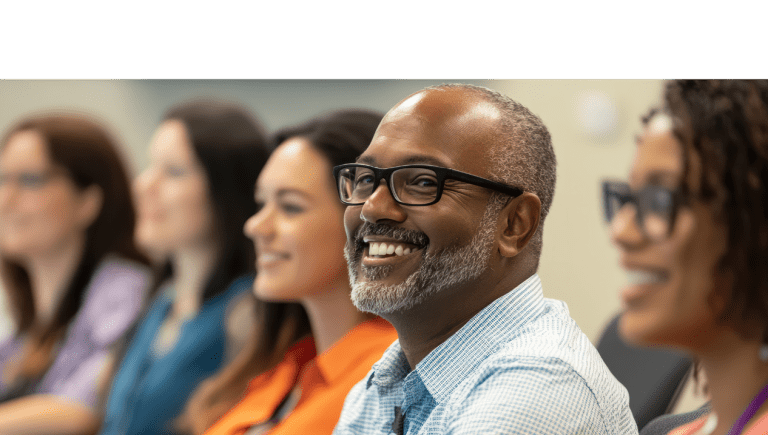 Image of people sitting and smiling