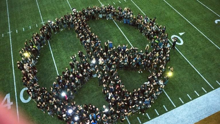 People standing in peace sign