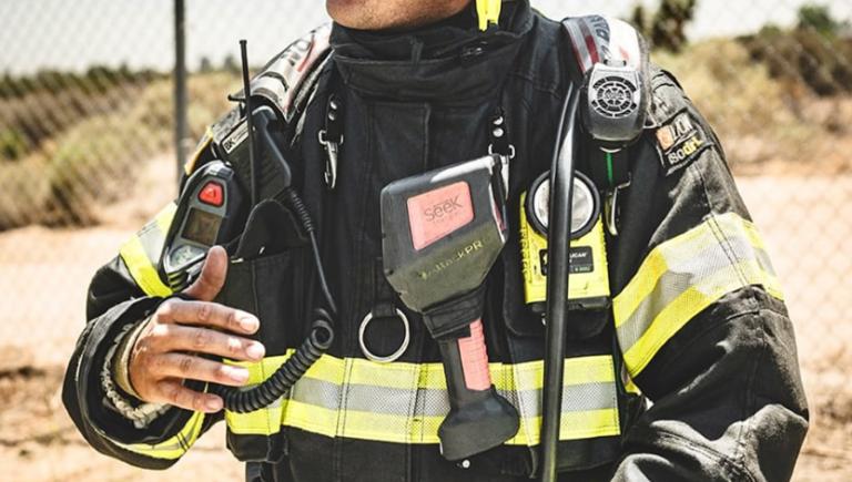 Zachary Humber in his fire fighting uniform and helmet