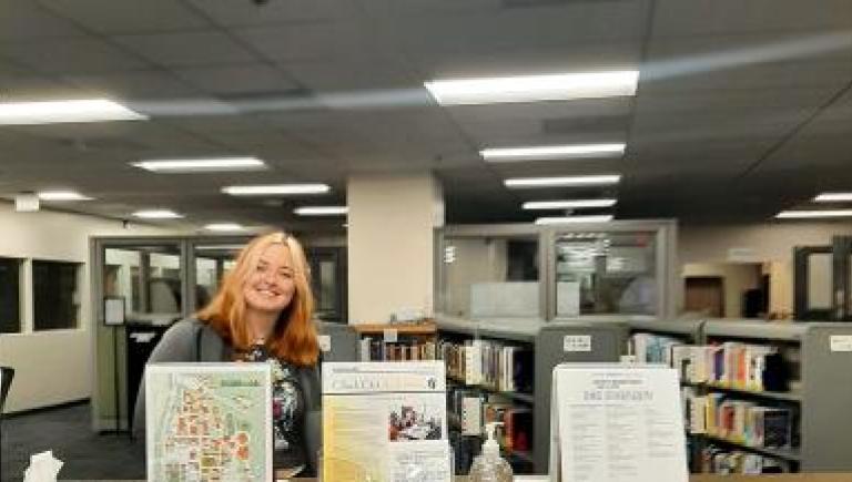 photo of student behind check out desk
