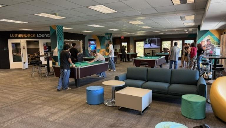 Students play pool and relax in the second-floor lounge at the Gutswurrak Student Activities Center.