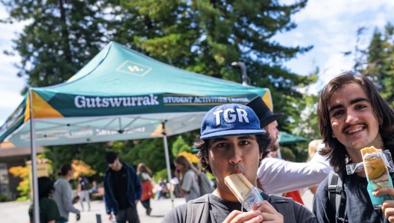 students enjoy popsicles during campus event on quad