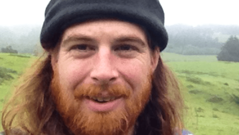 Image of Adam Canter standing on a foggy hill
