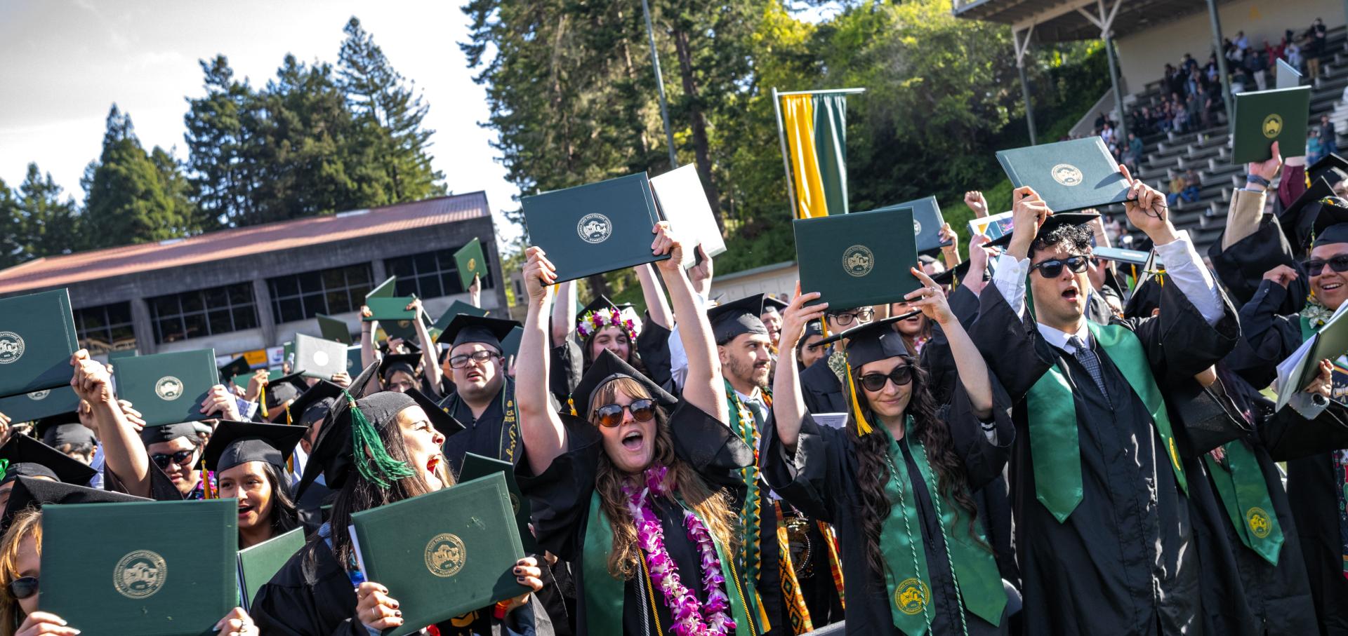 A photo of graduates celebrating.