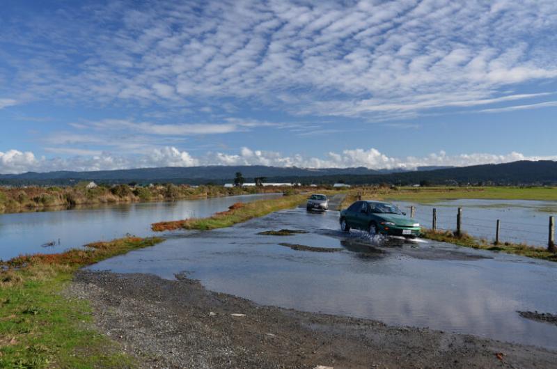 cars driving on flooded road