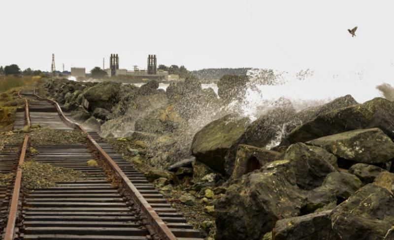image shows a sea wall protecting an old rail track from wave overwash