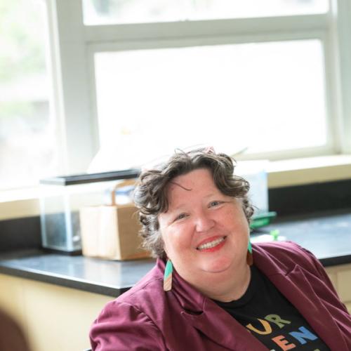 Amyk Conley portrait seated in a classroom.