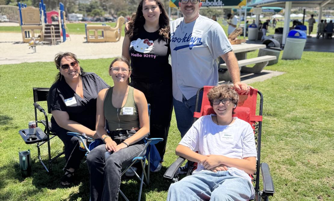 A family and their new Cal Poly Humboldt student in lawn chairs.
