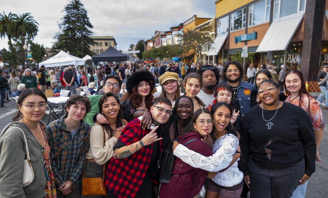 A group of Cal Poly Humboldt students posing together at the one of the Arcata Night Markets in 2025
