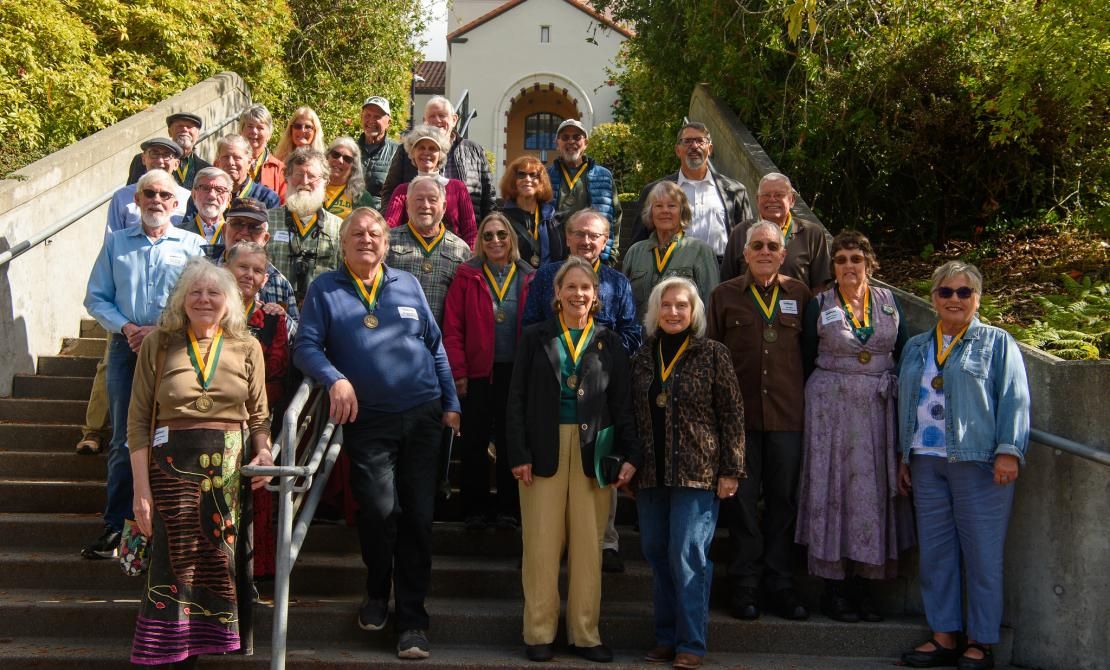 A group of Golden Graduates standing on the stairs of Founders Hall in 2025.