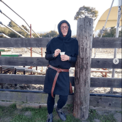 Person leaning against a fence
